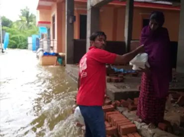 Distributing food packets among thousands of families during heavy floods.